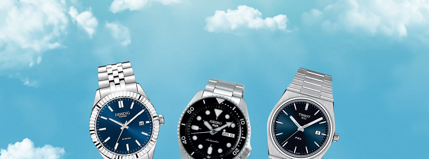 Desktop banner af tre ure på en blå himmel baggrund